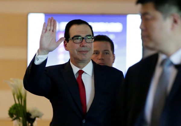 US Treasury Secretary Steven Mnuchin waves to the media as he and the US delegation for trade talks with China leave a hotel in Beijing, China, 3 May 2018 (Photo: Reuters/Jason Lee).