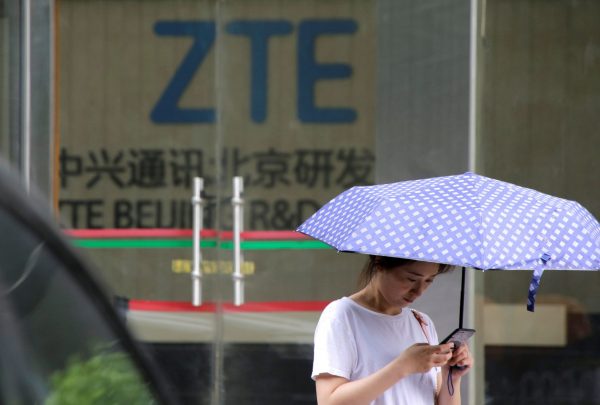A woman stands outside a building of ZTE Beijing research and development center in Beijing, China, 13 June 2018 (Photo: Reuters/Jason Lee).