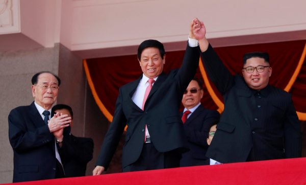 North Korean leader Kim Jong Un and China's Li Zhanshu, chairman of the Standing Committee of the National People's Congress holds hand in solidarity during a military parade marking the 70th anniversary of North Korea's foundation in Pyongyang, North Korea, 9 September 2018 (Photo: Reuters/Danish Siddiqui).