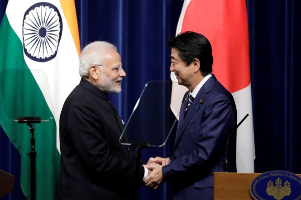 Narendra Modi, India's Prime Minister, and Shinzo Abe, Japan's Prime Minister, shake hands during a joint news conference at Abe's official residence in Tokyo, Japan, 29 October 2018 (Photo: Kiyoshi Ota/Pool via Reuters).