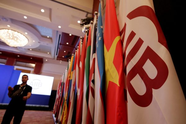 Flags of Asian Infrastructure Investment Bank (AIIB) and member states are set up for the opening ceremony of the first annual meeting of AIIB in Beijing, China, 25 June 2016 (Photo: Reuters/Jason Lee).
