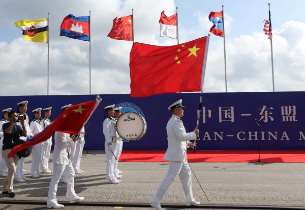 Members of the Chinese People's Liberation Army (PLA) and navy hold Chinese flags during the opening ceremony of the first China-ASEAN Maritime Exercise in Zhanjiang, Guangdong province, China, 22 October 2018 (Photo: Reuters/Stringer).