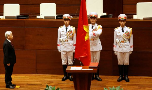 Vietnam's Communist Party General Secretary Nguyen Phu Trong stands at attention in front of the Consitution during the swearing-in ceremony after being elected as Vietnam's State President during a National Assembly session in Hanoi, Vietnam, 23 October 2018 (Photo: Reuters/Kham).