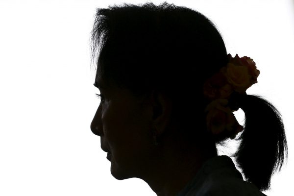 Myanmar's pro-democracy leader Aung San Suu Kyi is silhouetted as she speaks to Reuters reporters during an exclusive interview in her office at the parliament in Naypyidaw, 3 April 2015 (Photo: Reuters/Soe Zeya).