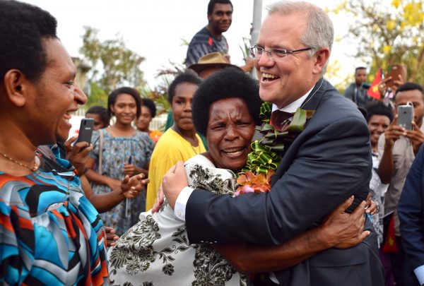 Australia's Prime Minister Scott Morrison is hugged by a woman as he greets locals at the opening of a new building at the University of Papua New Guinea after the Asia Pacific Economic Cooperation forum in Port Moresby, Papua New Guinea, 18 November 2018 (Reuters/Mick Tsikas).