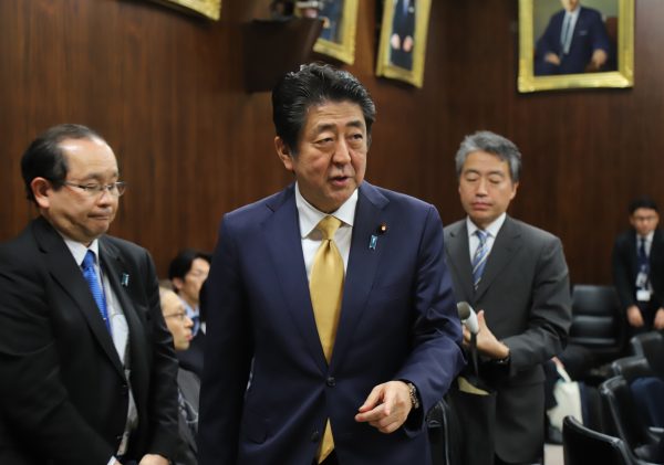 Japanese Prime Minister Shinzo Abe leaves an Upper House judicial committee session at the National Diet in Tokyo, 6 December 2018. The Abe cabinet and ruling coalition try to pass the controversial immigration bill on 7 December while opposition parties demand dismissal of the committee chairman (Photo: Reuters/Yoshio Tsunoda/AFLO).