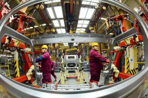 Employees work on a production line manufacturing light trucks at a JAC Motors plant in Weifang, Shandong Province, China, 30 November 2018 (Photo: Reuters/Stringer).