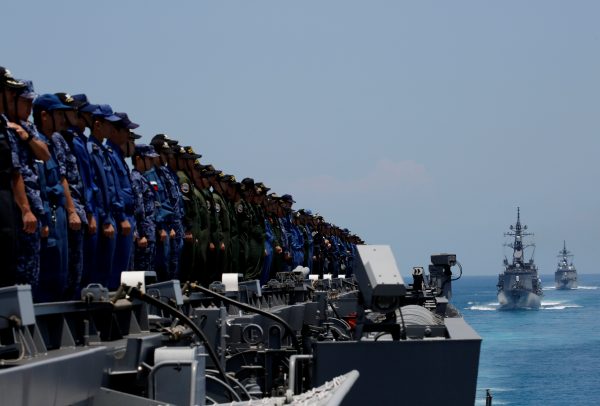 Sailors on Japanese helicopter carrier Kaga wait as Japanese destroyers Inazuma and Suzutsuki approach during a joint naval drill in the Indian Ocean, Indonesia, 22 September 2018 (Reuters/Kim Kyung-hoon).