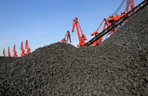 Cranes unload coal from a cargo ship at a port in Lianyungang, Jiangsu Province, China, 8 December 2018 (Photo: Reuters/Stringer).