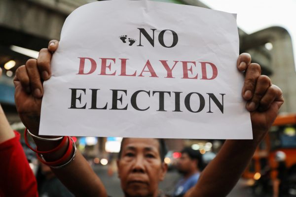 An activist holds a placard to demand the first election in Thailand since the military seized power in a 2014 coup, Bangkok, Thailand, 8 January 2019 (Photo: Reuters/Jorge Silva).
