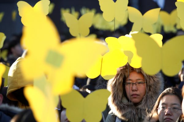People hold up yellow coloured butterflies dedicated to Kim Bok-dong, a former South Korean comfort woman, during her funeral in Seoul, South Korea, 1 February 2019 (Photo: Reuters/Kim Hong-ji).