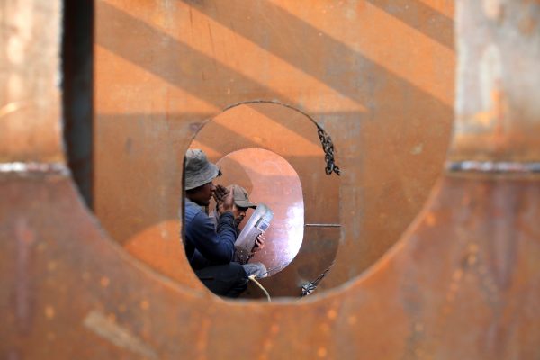 Workers weld iron sheets as they build a new ferry at a dockyard in Dhaka, Bangladesh, 7 February 2019 (Photo: Reuters/Mohammad Ponir Hossain).