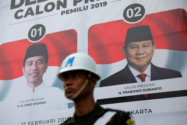 An officer guards the second debate between presidential candidates ahead of the next general election in Jakarta, Indonesia, 17 February 2019 (Photo: Reuters/Willy Kurniawan).