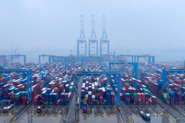 Containers and trucks are seen on a snowy day at an automated container terminal in Qingdao port, Shandong province, China, 10 December 2018 (Photo: Reuters/Stringer).