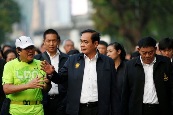 Thailand's Prime Minister Prayut Chan-o-cha talks with a man as he visits Lumphini Park ahead of the general election, in Bangkok, Thailand, 20 March 2019 (Photo: Reuters/Soe Zeya Tun).