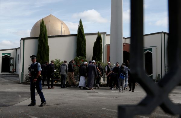 A policeman stands guard as members of the Muslim community visit Al-Noor mosque after it was reopened in Christchurch, New Zealand, 23 March 2019 (Photo: Reuters/Edgar Su).
