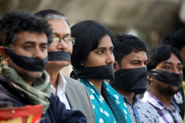 Activists of leftist alliance cover their mouth with black cloths as they join in a rally to demand a new election under caretaker government, in Dhaka, Bangladesh, 3 January 2019 (Photo: Reuters/Mohammad Ponir Hossain).