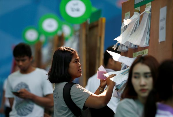 A woman looks at the candidate list of the upcoming Thai election at a polling station in Bangkok, Thailand 17 March 2019. (Photo: Reuters/Soe Zeya Tun)