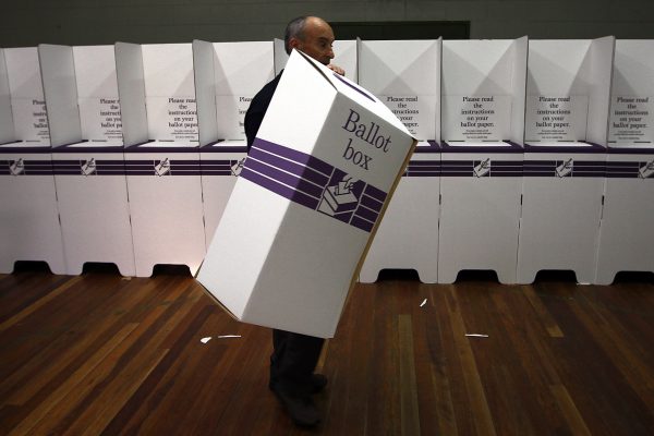 An electoral officer puts together ballot boxes and voting booths (Photo: Reuters/David Gray).