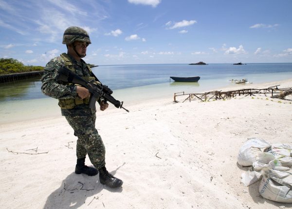 A Filipino soldier patrols at the shore of Thitu Island (Photo: Reuters/Ritchie B. Tongo).