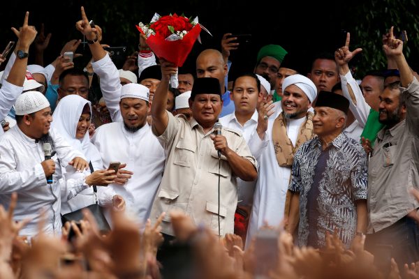 Indonesia's presidential candidate Prabowo Subianto holds flowers from a supporter, as he gives a speech after this week's presidential election in Jakarta, Indonesia, 19 April 2019 (Photo: Reuters/Willy Kurniawan).