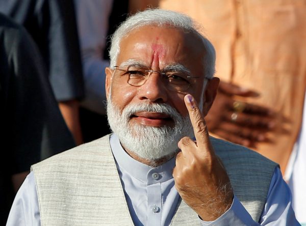 India's Prime Minister Narendra Modi shows his ink-marked finger after casting his vote outside a polling station during the third phase of general election in Ahmedabad, India, 23 April 2019 (Photo: Reuters/Amit Dave).