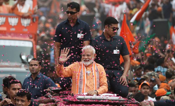India's Prime Minister Narendra Modi waves towards his supporters during a roadshow in Varanasi, India, 25 April 2019 (Photo: Reuters/Adnan Abidi).