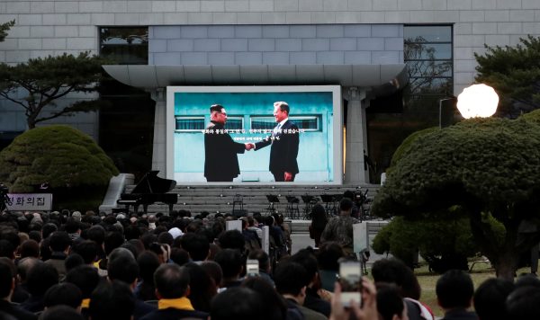 A screen showing a picture of South Korean President Moon Jae-in and North Korean leader Kim Jong Un, is seen during a ceremony to mark the first anniversary of Panmunjom declaration outside of the Peace House at the southern side of Panmunjom in the Demilitarised Zone, South Korea, 27 April 2019. (Photo: Reuters. Lee Jin-man)