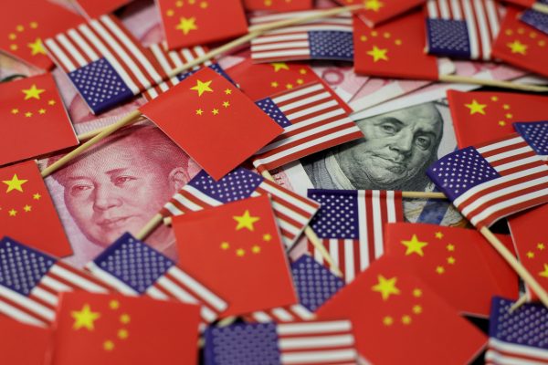 A US dollar banknote featuring American founding father Benjamin Franklin and a China's yuan banknote featuring late Chinese chairman Mao Zedong among US and Chinese flags in this illustration. Picture taken 20 May 2019. (Photo: REUTERS/Jason Lee)