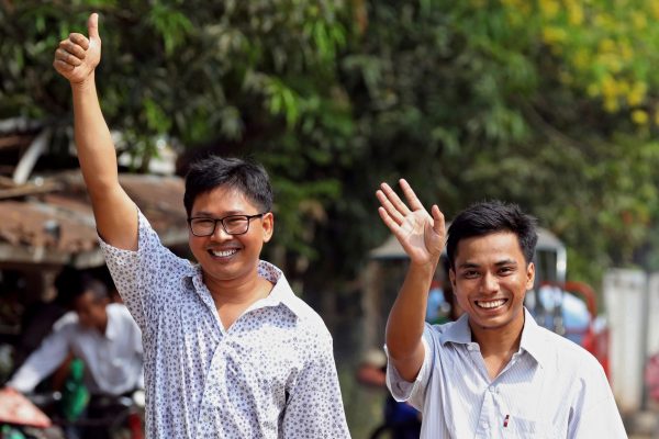 Reuters reporters Wa Lone and Kyaw Soe Oo gesture as they walk to Insein prison gate after being freed, after receiving a presidential pardon in Yangon, Myanmar, 7 May 2019. REUTERS/Ann Wang