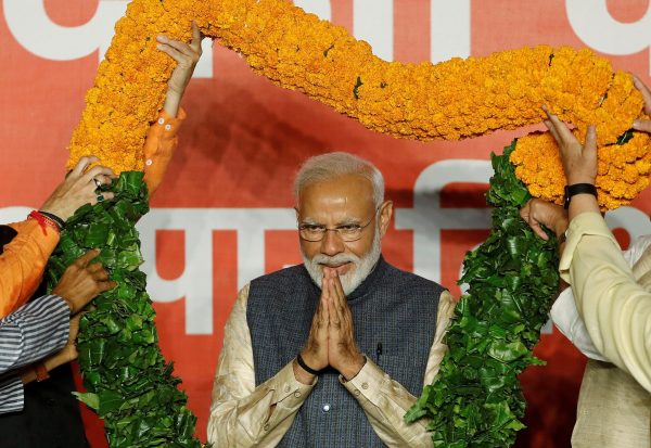 Indian Prime Minister Narendra Modi gestures as he is presented with a garland by Bharatiya Janata Party (BJP) leaders after the election results in New Delhi, India, 23 May 2019. (Photo: REUTERS/Adnan Abidi)