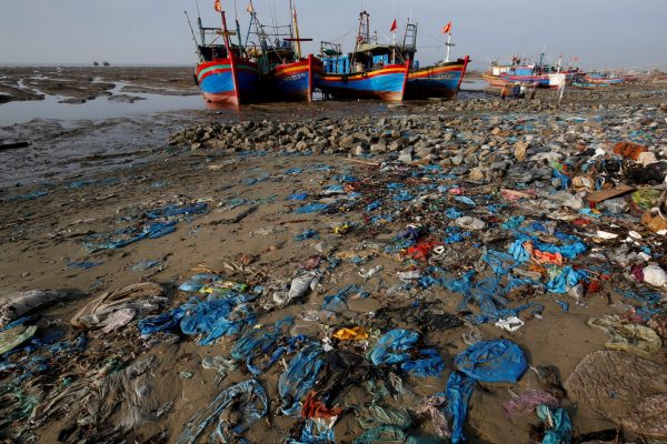 Fishermens’ boats are seen at a beach covered with plastic waste in Thanh Hoa province, Vietnam, 4 June 2018 (Photo: Reuters/Kham).