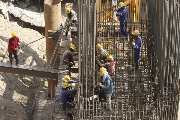 Workers build on a Chinese-funded bridge. (Photo: Reuters/Samrang Pring).