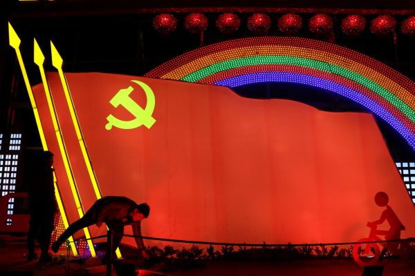 Men check on a light installation in a shape of the party flag of the Communist Party of China in Jining, Shandong province, China, 29 January 2019 (Photo: Reuters/Stringer)