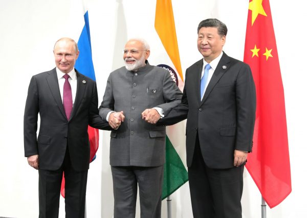 Russia's President Vladimir Putin (L), India's Prime Minister Narendra Modi (C) and China’s President Xi Jinping pose for a picture during a meeting on the sidelines of the G20 summit in Osaka, Japan, 28 June 2019 (Photo: Reuters/Sputnik/Mikhail Klimentyev).