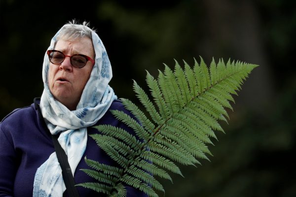 A woman holds a fern during a vigil for the victims of the mosque attacks during an ecumenical celebration in Christchurch, New Zealand, March 21, 2019. (Photo: Reuters/Jorge Silva).