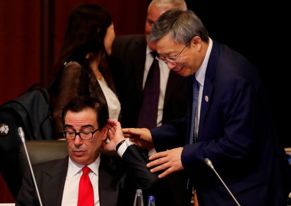 China's Central Bank Governor Yi Gang approaches to greet US Treasury Secretary Steven Mnuchin during the G20 finance ministers and central bank governors meeting in Fukuoka, Japan, 8 June 2019 (Photo: Reuters/Kim Kyung-Hoon).