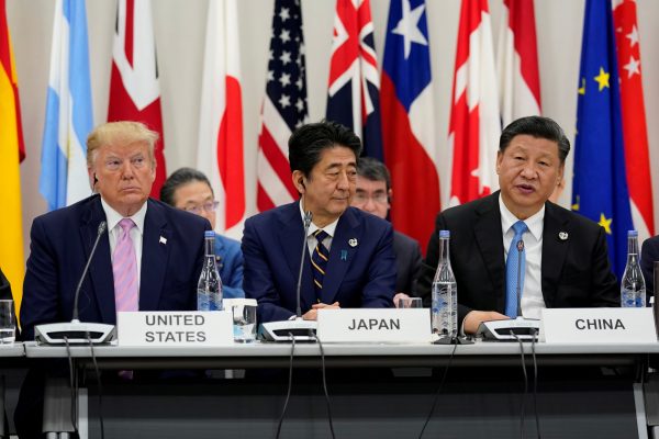 Japan's Prime Minister Shinzo Abe is flanked by US President Donald Trump and China's President Xi Jinping during a meeting at the G20 leaders summit in Osaka, Japan, 28 June 2019 (Photo: Reuters/Kevin Lamarque).