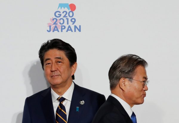 South Korean President Moon Jae-In is welcomed by Japanese Prime Minister Shinzo Abe upon his arrival for a welcome and family photo session at G20 leaders summit in Osaka, Japan, 28 June 2019 (Photo: Reuters/Kim Kyung-Hoon)