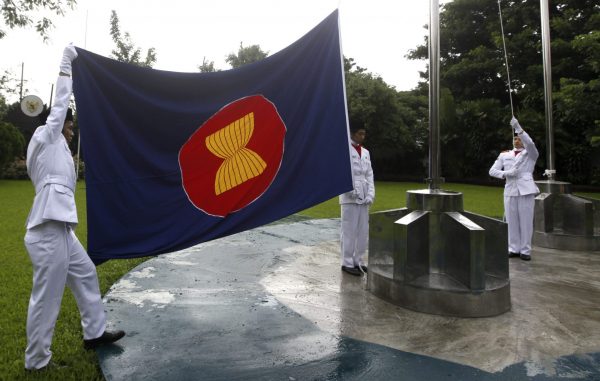 Embassy staff raise the ASEAN flag during a ceremony to mark the 44th anniversary of the Association of South East Asian nations (ASEAN) at the Indonesian embassy in Yangon. (Photo: Reuters/Soe Zeya Tun).