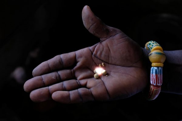 A person holds gold recovered at the end of the informal gold mining process, after the mercury has been burned off, in Bawdie, Ghana, 4 April 2019 (Photo: Reuters/Francis Kokoroko)