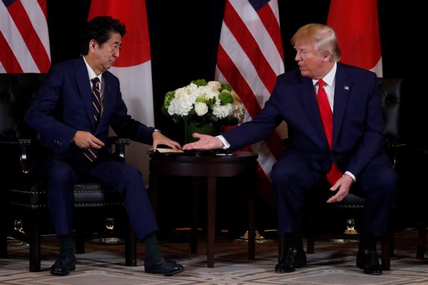 US President Donald Trump reaches out to shake hands with Japan's Prime Minister Shinzo Abe during a bilateral meeting on the sidelines of the 74th session of the United Nations General Assembly (UNGA) in New York City, New York, US, 25 September 2019 (Photo: Reuters/Jonathan Ernst).