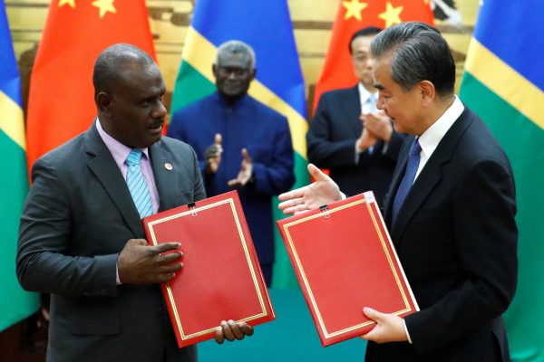 Chinese State Councillor and Foreign Minister Wang Yi and Solomon Islands Foreign Minister Jeremiah Manele attend a signing ceremony at the Great Hall of the People in Beijing, China, 9 October 2019 (Photo: Reuters/Thomas Peter).