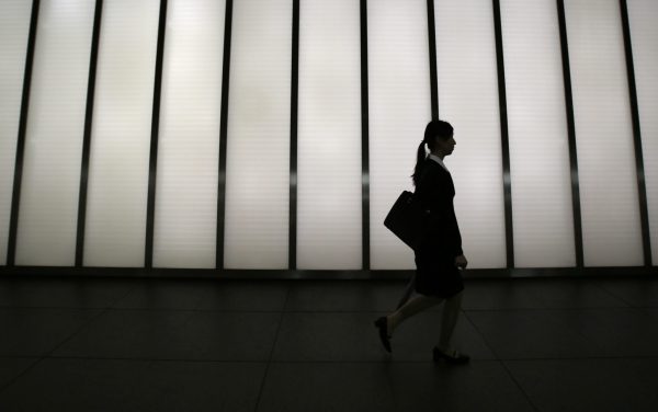 A job seeker walks past a corridor of a commercial building in Tokyo, Japan, 28 August 2014 (Photo: Reuters/Yuya Shino).