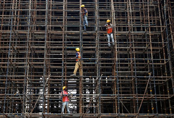 Labourers work at a construction site of a metro rail station in India, 2 July 2018 (Photo: Reuters/Rupak De Chowdhuri).