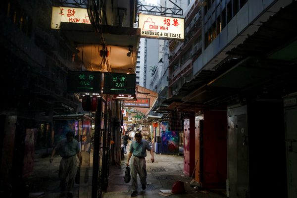 A man walks between stalls in an alley in the Central business district in Hong Kong, 22 August, 2019 (Photo: Reuters/Thomas Peter).