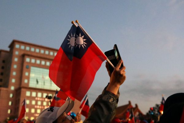 A Kuomintang party supporter holds Taiwanese flags before an election rally in Taipei, Taiwan, 9 January 2020 (Photo: Reuters/Ann Wang).
