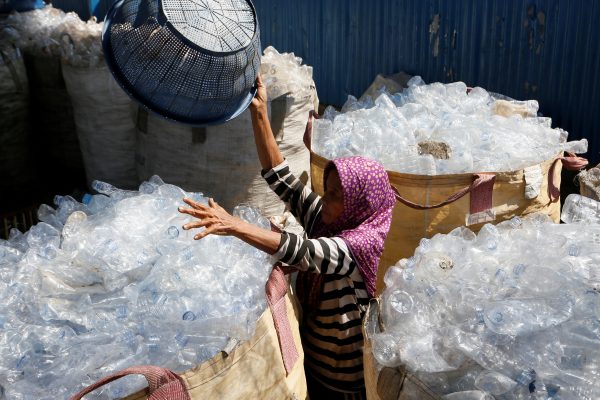 A worker sorts used plastic bottles to be recycled at a plastic recycling centre in Denpasar, Bali, Indonesia, 21 June, 2019 (Photo: Reuters/Christo).