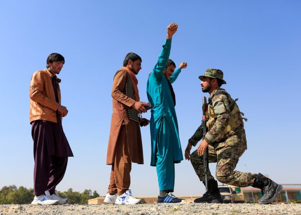 An Afghan National Army soldier inspects passengers at a checkpoint in Khogyani district of Nangarhar province, Afghanistan, 23 February (Photo: Reuters/Parwiz).