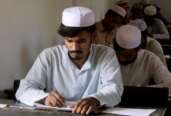 A student of a madrassa (religious school) writes during an examination in Kolkata, eastern India, 7 March 2006 (Photo: Reuters/Jayanta Shaw).